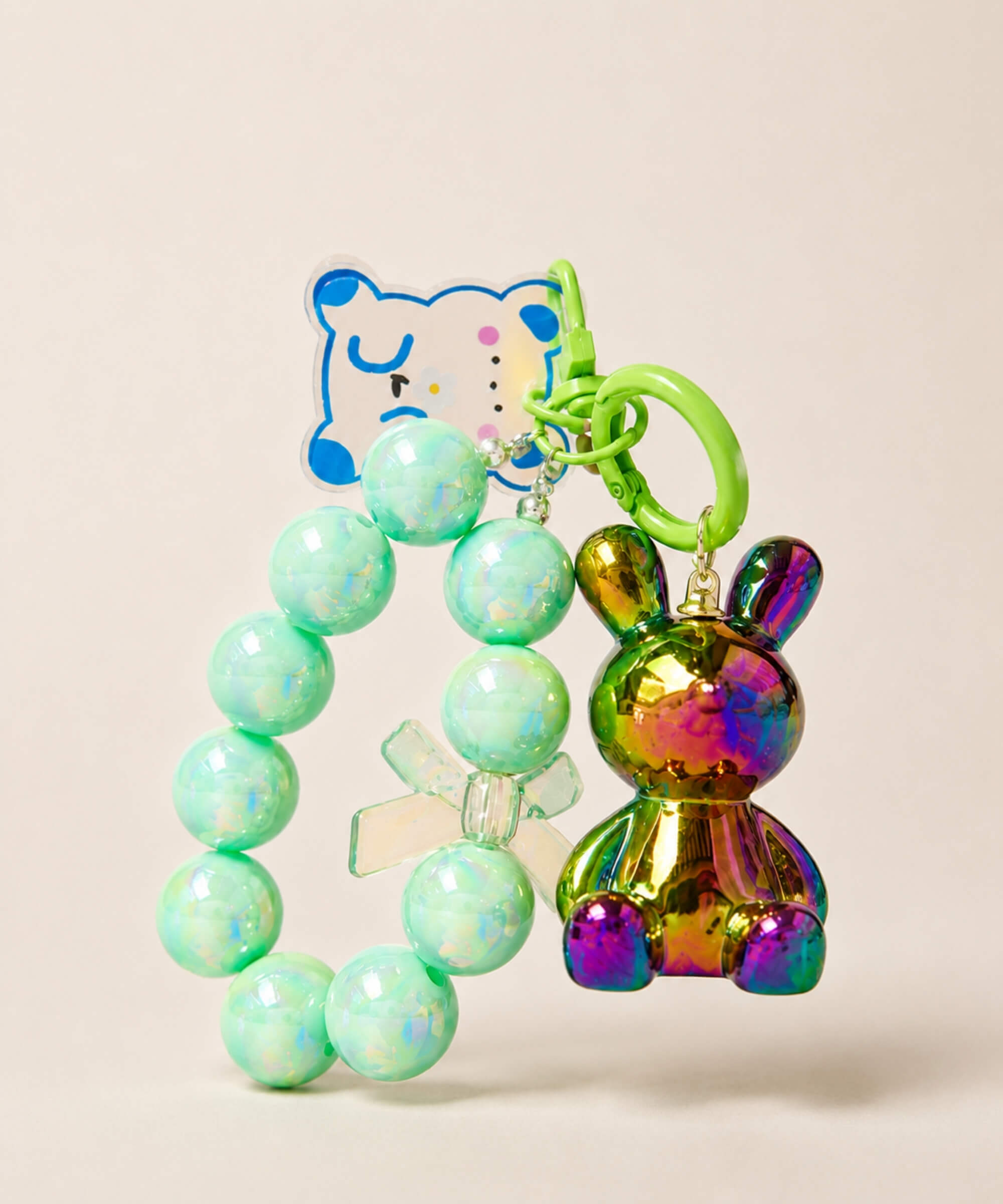 Green bunny beaded keychain with iridescent rabbit charm and bow detail on a neutral background